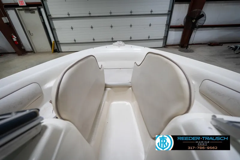 Slide: The Image of 1995 Sea Ray 175 Bow Rider interior with blue and white seating, featuring storage compartments. - 22