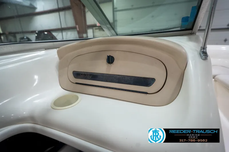 Slide: The Image of 1995 Sea Ray 175 Bow Rider interior with white seating in a garage setting. - 25