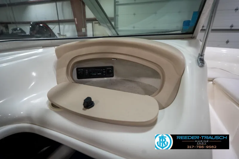 Slide: The Image of 1995 Sea Ray 175 Bow Rider interior with white seating in a garage setting. - 26