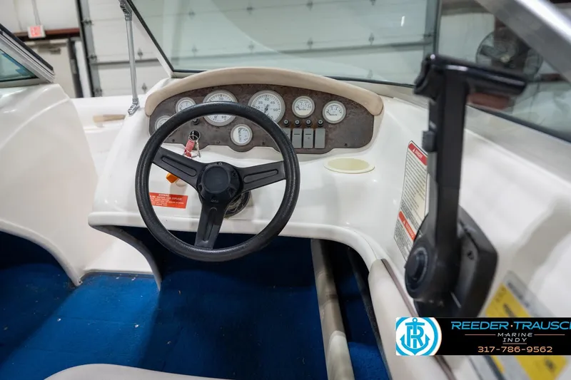Slide: The Image of 1995 Sea Ray 175 Bow Rider interior with steering wheel and dashboard gauges. - 27