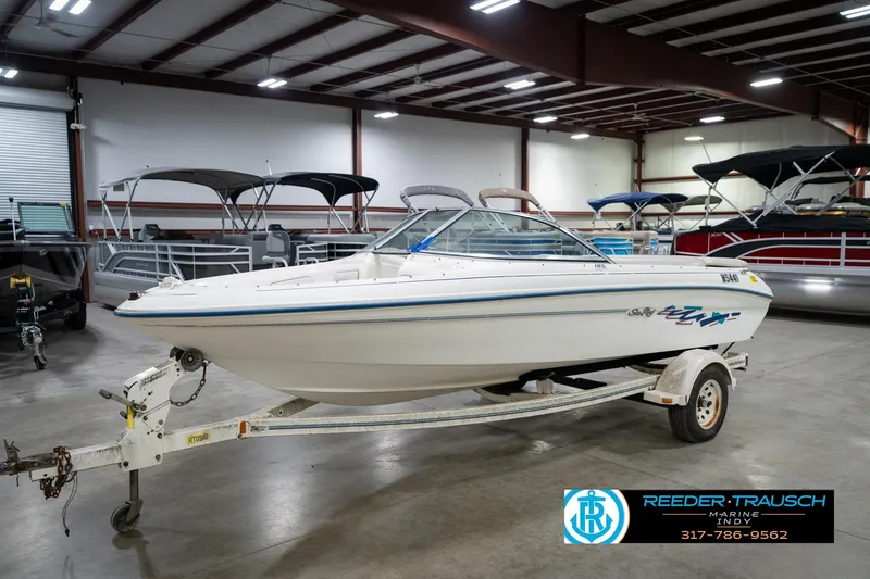 The Image of 1995 Sea Ray 175 Bow Rider boat on trailer in indoor showroom. - 3