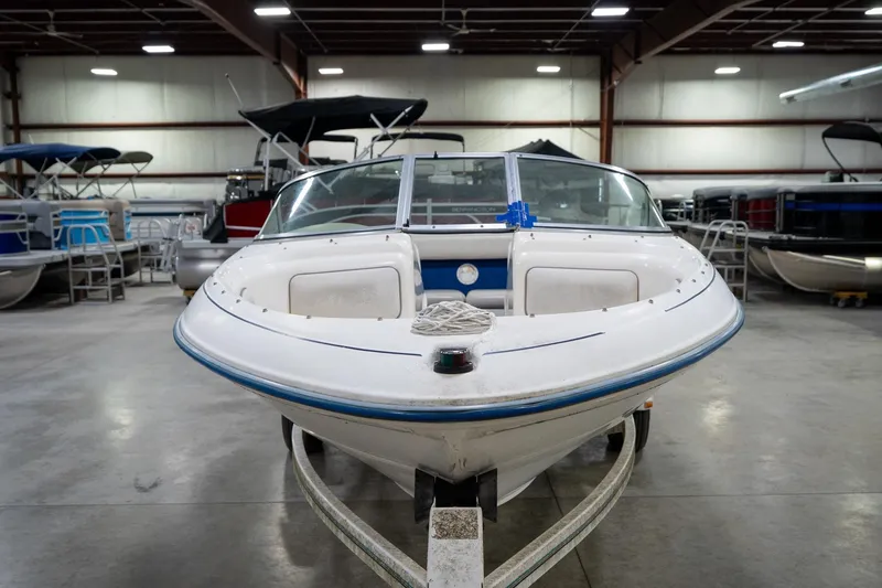 Slide: The Image of 1995 Sea Ray 175 Bow Rider boat on trailer in indoor showroom. - 4