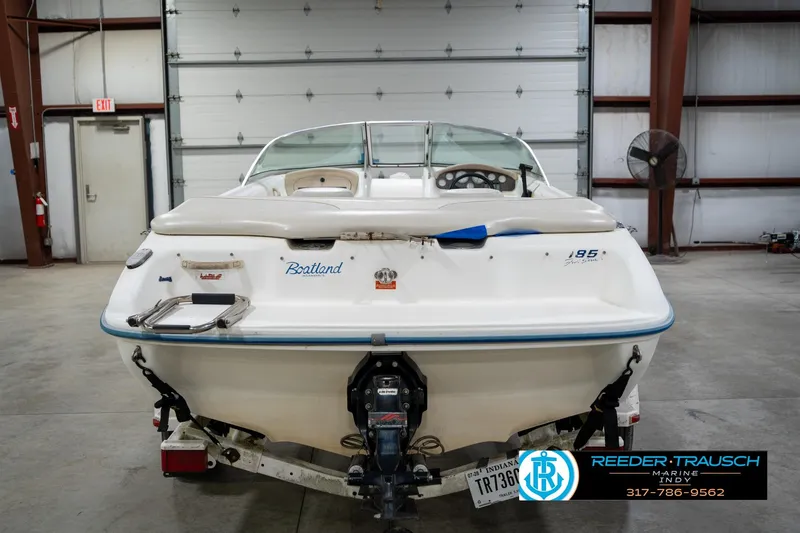 Slide: The Image of 1995 Sea Ray 175 Bow Rider boat on trailer in indoor showroom. - 8