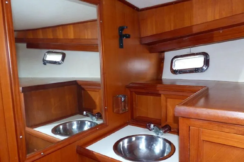 Slide: The Image of 1987 Marine Trader Sundeck interior with wooden cabinetry and stainless steel sink. - 14
