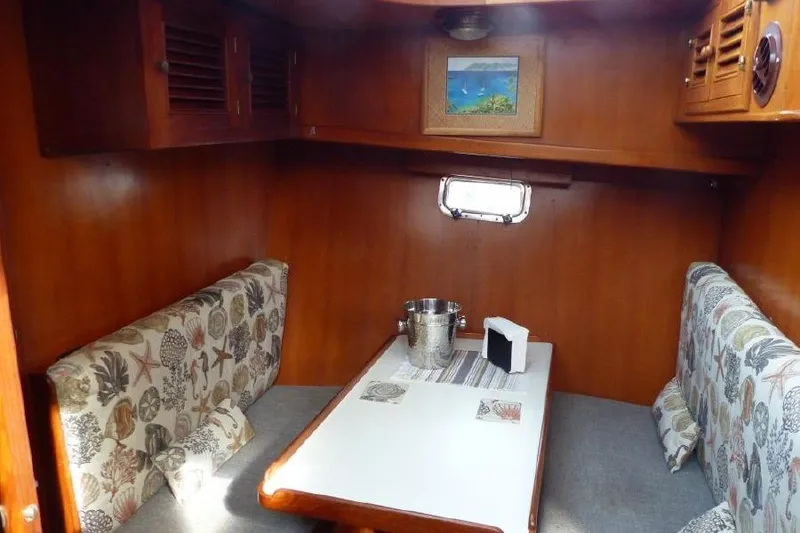 Slide: The Image of 1987 Marine Trader Sundeck interior with cozy dining area and nautical decor. - 15