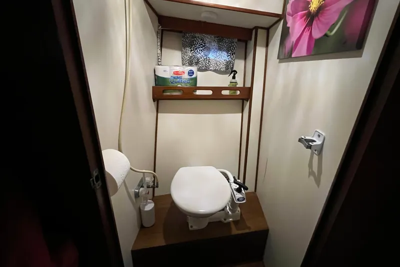 Slide: The Image of Compact bathroom in 1987 Marine Trader Sundeck boat with toilet and shelf. - 18
