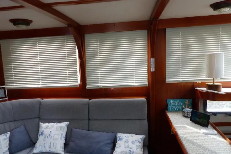 Slide: The Image of Interior of 1987 Marine Trader Sundeck with blinds, sofa, and decorative pillows. - 21