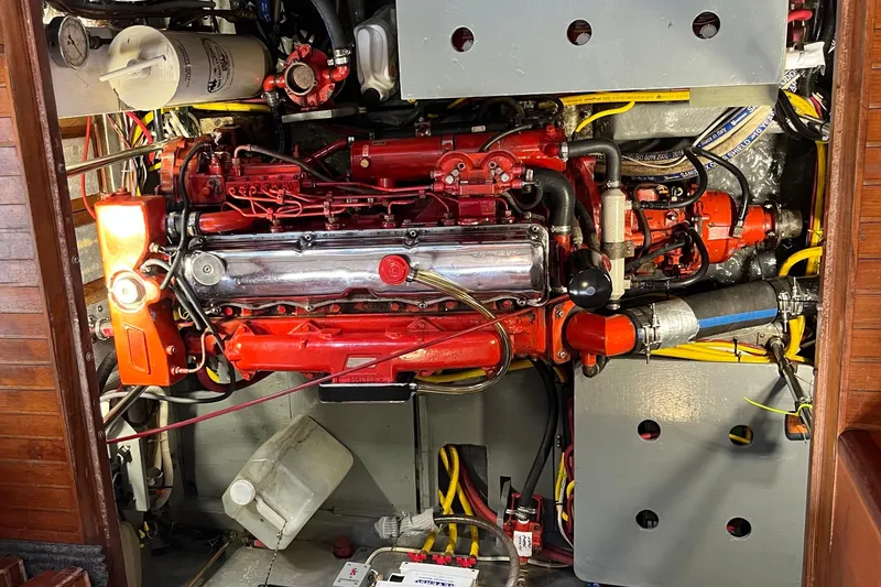 Slide: The Image of Engine compartment of a 1987 Marine Trader Sundeck boat, showcasing detailed mechanical components. - 29