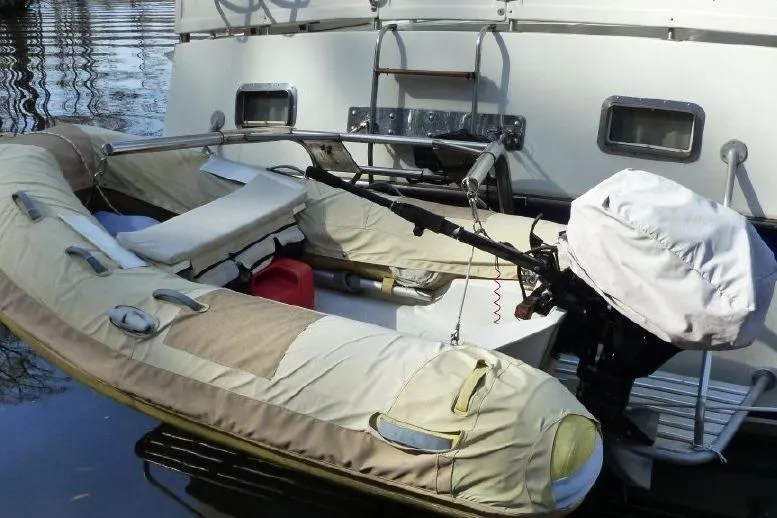 Slide: The Image of 1987 Marine Trader Sundeck with inflatable dinghy and outboard motor attached. - 39