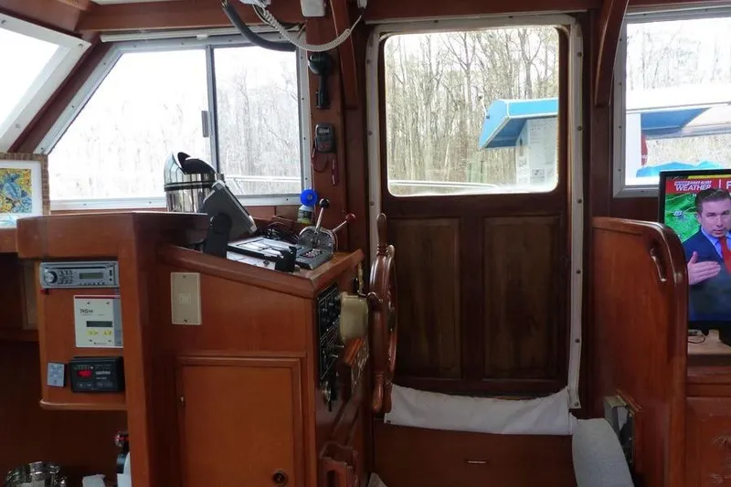 Slide: The Image of Interior of 1987 Marine Trader Sundeck boat with navigation equipment and TV. - 8