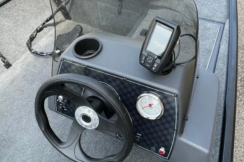 Slide: The Image of 2024 Tracker Bass Tracker Classic XL dashboard with steering wheel and Garmin fishfinder. - 5