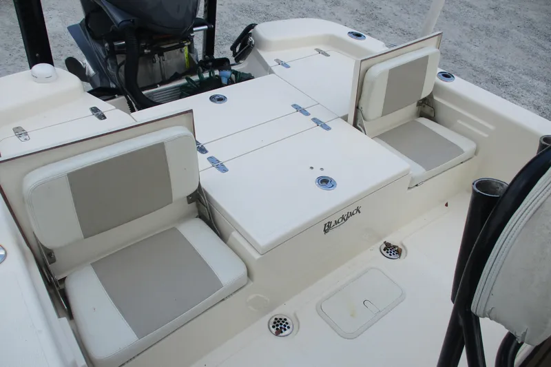 Slide: The Image of 2016 BlackJack 256 Bay boat interior with seating and storage compartments. - 12