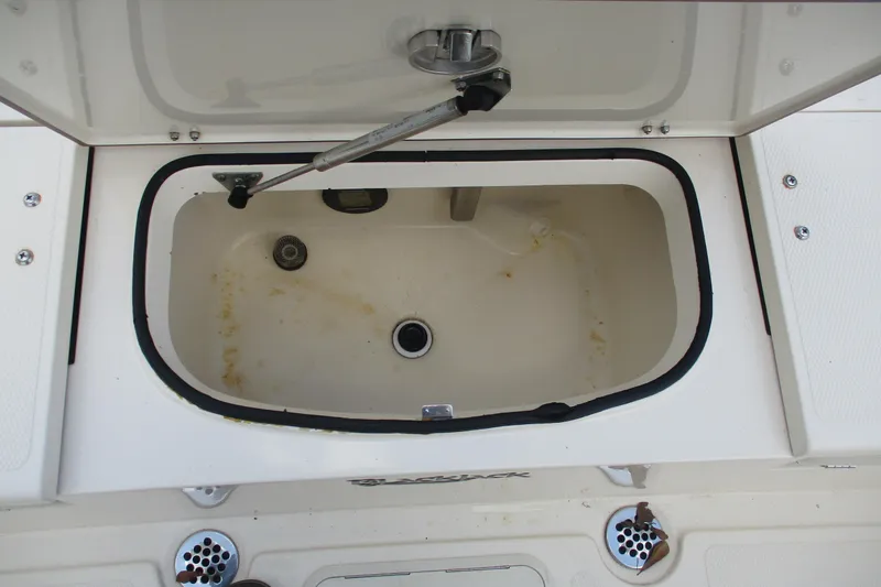 Slide: The Image of Open storage compartment on a 2016 BlackJack 256 Bay boat. - 15