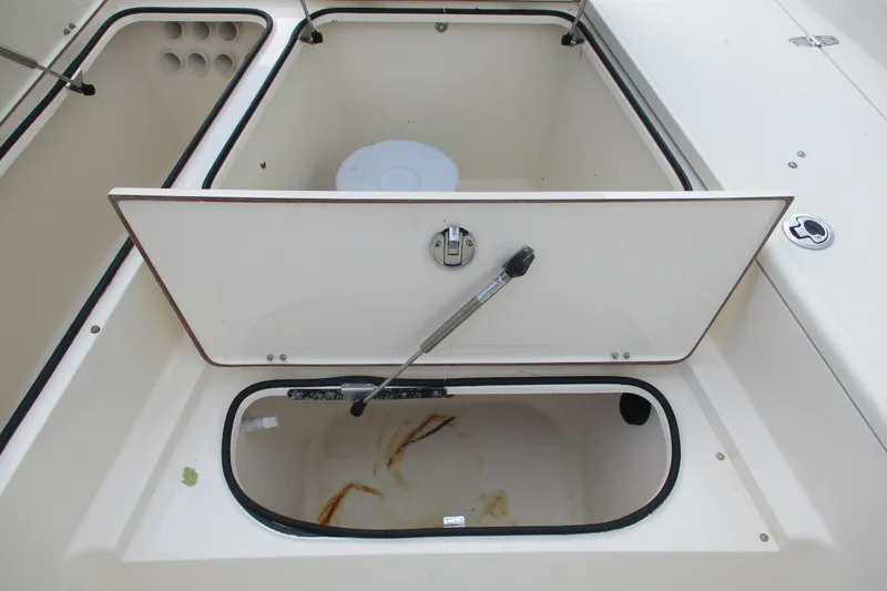 Slide: The Image of Open storage compartment on a 2016 BlackJack 256 Bay boat, showcasing interior space. - 17