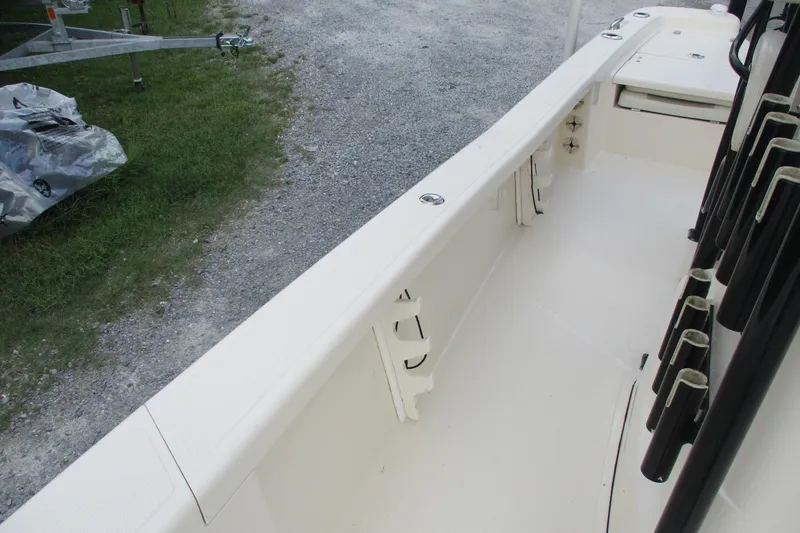 Slide: The Image of 2016 BlackJack 256 Bay boat interior with rod holders and clean deck. - 19