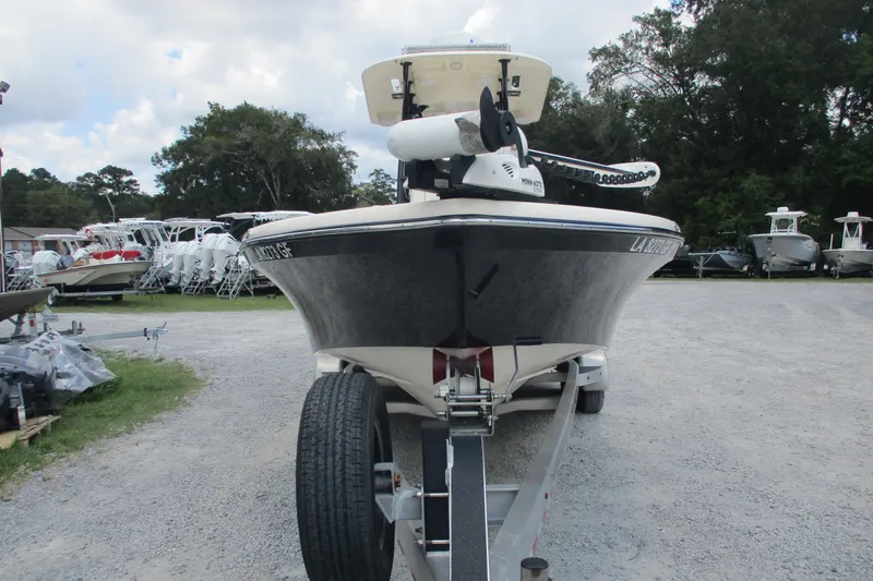 Slide: The Image of 2016 BlackJack 256 Bay boat on trailer, parked outdoors with other boats. - 2