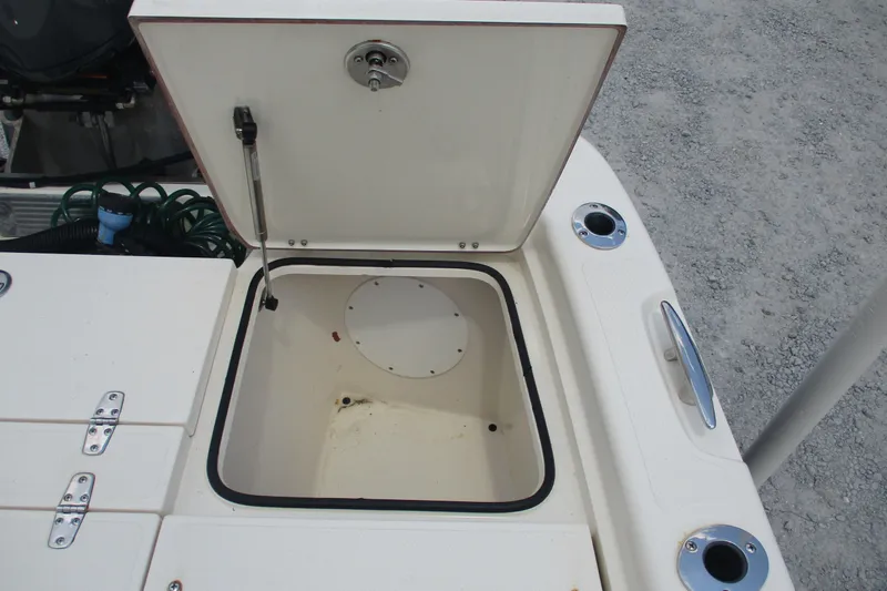 Slide: The Image of Open storage compartment on 2016 BlackJack 256 Bay boat, showing interior details. - 20