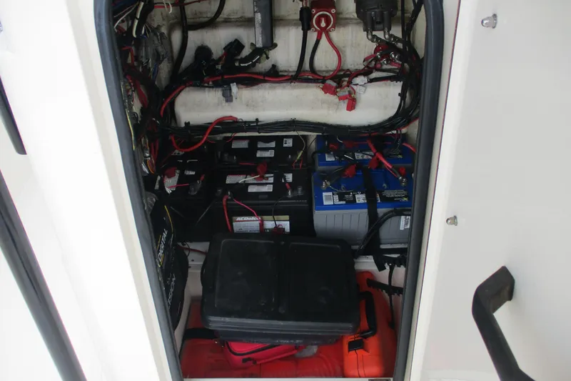 Slide: The Image of 2016 BlackJack 256 Bay boat battery compartment with wiring and equipment. - 21