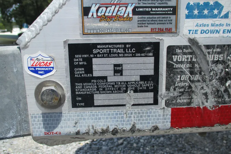 Slide: The Image of Trailer information labels with manufacturer details and warranty stickers. - 24