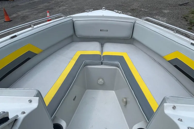 Slide: The Image of 1988 Donzi Open Bow boat interior with gray and yellow seating. - 10