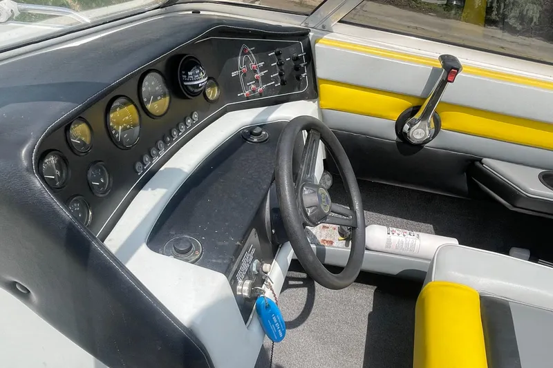 Slide: The Image of 1988 Donzi Open Bow boat dashboard with steering wheel and control panel. - 11