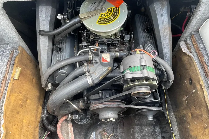 Slide: The Image of Engine compartment of a 1988 Donzi Open Bow boat, showing detailed mechanical components. - 16