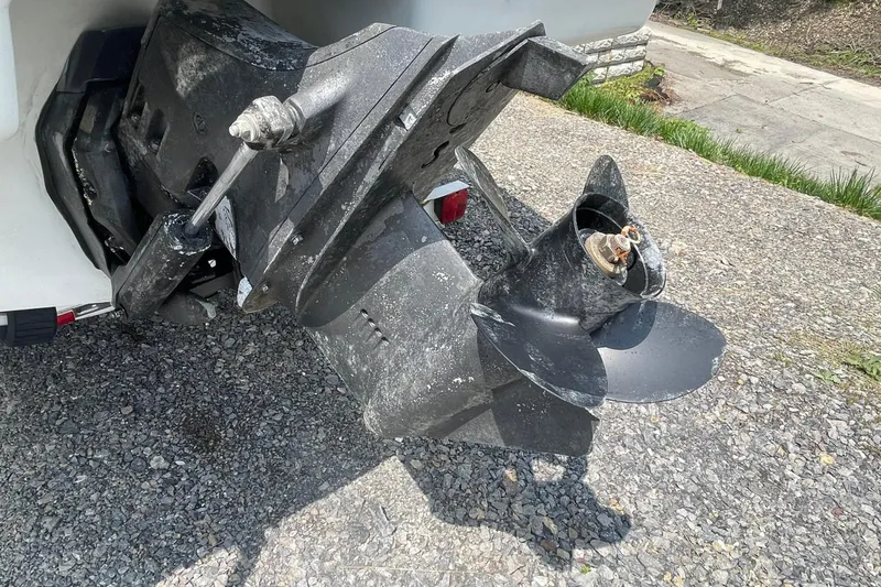 Slide: The Image of 1988 Donzi Open Bow boat propeller and drive system on gravel surface. - 17