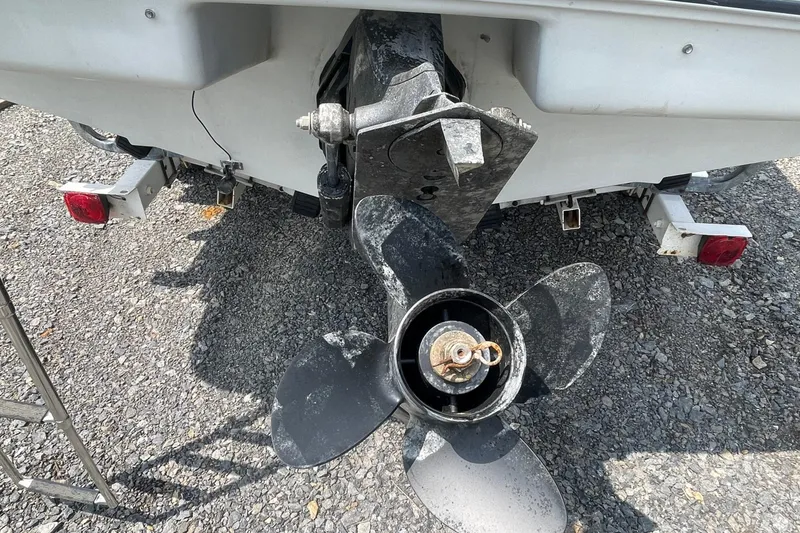 Slide: The Image of 1988 Donzi Open Bow boat propeller and stern on gravel surface. - 18