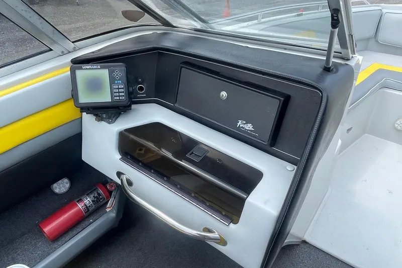 Slide: The Image of 1988 Donzi Open Bow boat dashboard with Lowrance GPS and fire extinguisher. - 9