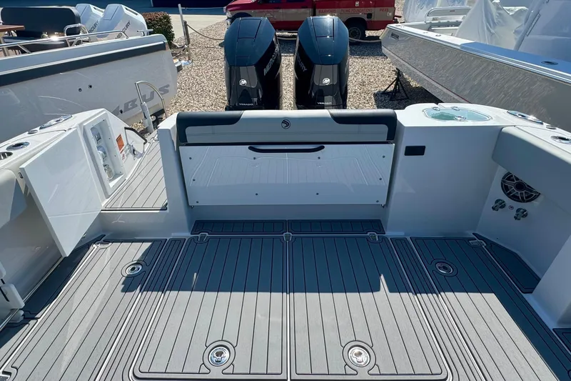 Slide: The Image of Twin Mercury Verado engines on a 2025 Edgewater 340CC boat, parked outdoors. - 10