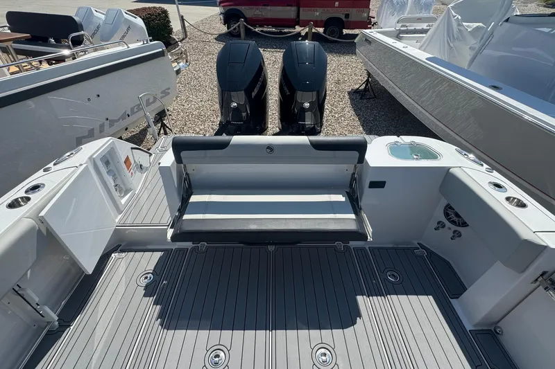 Slide: The Image of 2025 Edgewater 340CC boat with dual Mercury engines and sleek deck design. - 11