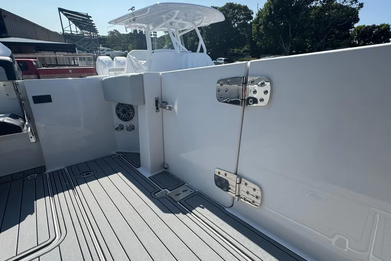 Slide: The Image of 2025 Edgewater 340CC boat deck with twin outboard engines, featuring sleek design and modern amenities. - 12