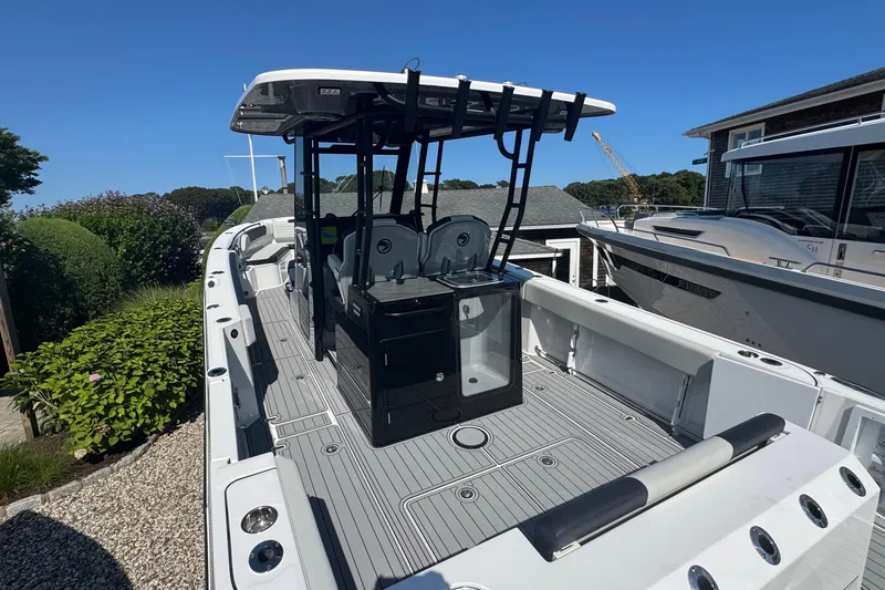 Slide: The Image of 2025 Edgewater 340CC boat interior with seating and dual outboard motors. - 13