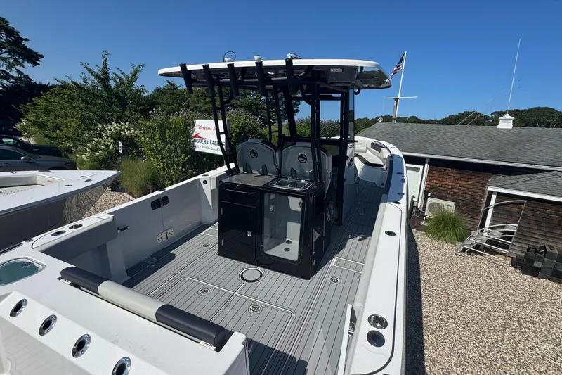 Slide: The Image of Edgewater 340CC 2025 boat at Modern Yachts dealership under clear blue sky. - 17