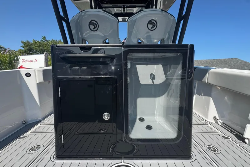 Slide: The Image of 2025 Edgewater 340CC boat interior with sleek design and modern features, under clear blue sky. - 18
