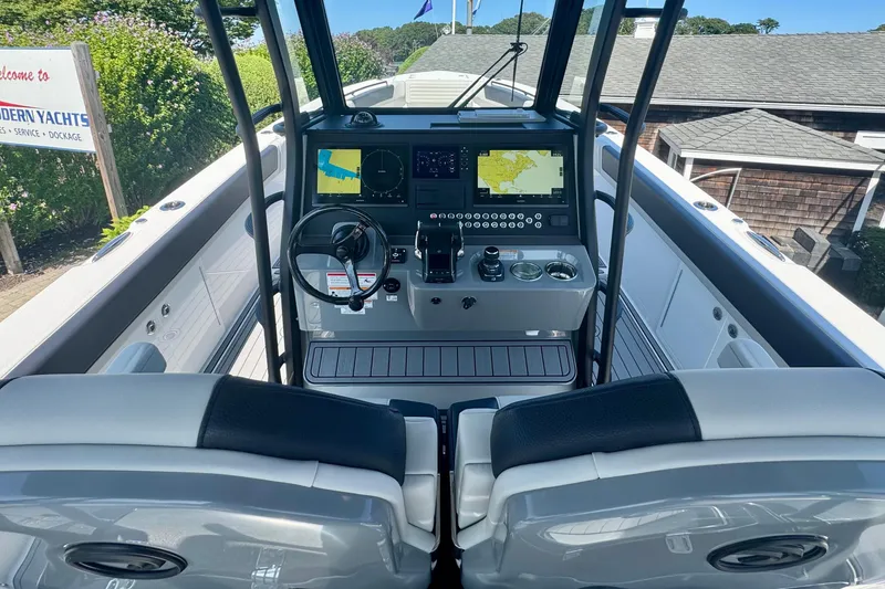 Slide: The Image of 2025 Edgewater 340CC boat interior with sleek black cabinetry and seating. - 20