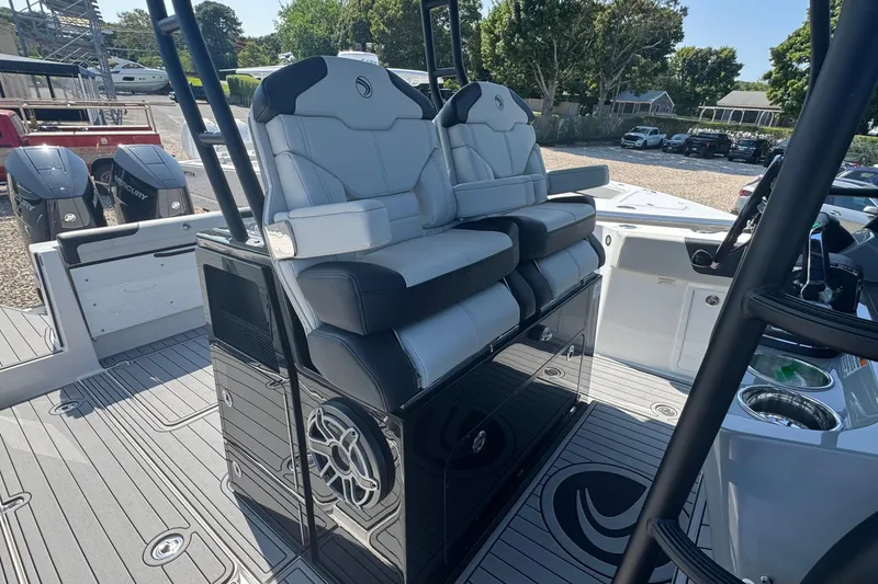 Slide: The Image of 2025 Edgewater 340CC boat cockpit with modern navigation system and comfortable seating. - 25