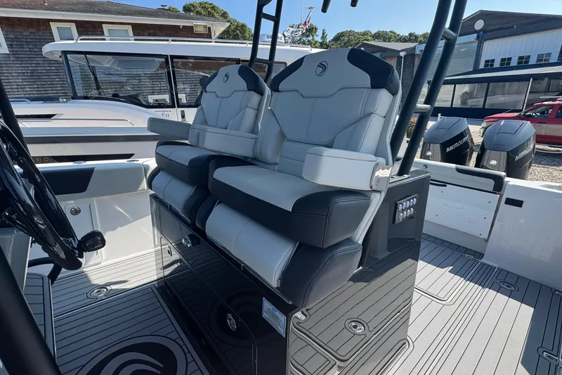 Slide: The Image of 2025 Edgewater 340CC boat interior with luxury seating and modern controls. - 26
