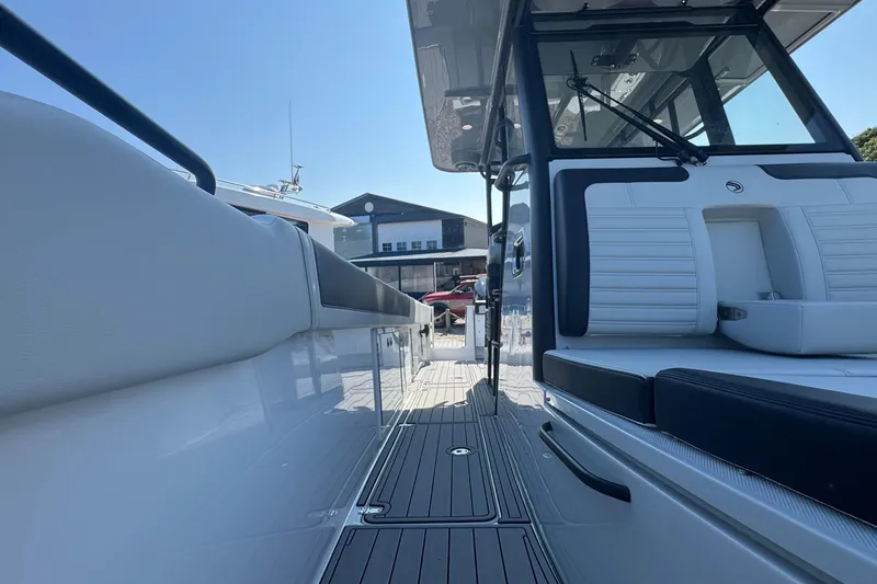 Slide: The Image of 2025 Edgewater 340CC boat interior with cushioned seating and modern design. - 34