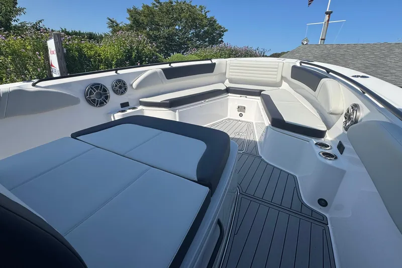 Slide: The Image of 2025 Edgewater 340CC boat with sleek design and spacious seating, docked outdoors. - 39