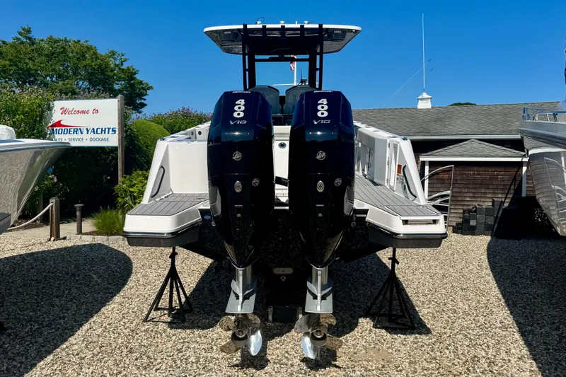 Slide: The Image of Aerial view of 2026 Edgewater 340CC boat on calm green water. - 5