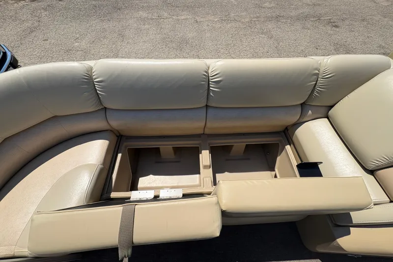 Slide: The Image of Beige leather seating with storage compartments on a 2012 Bennington 2575 QCW I/O boat. - 10