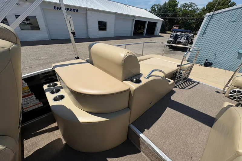 Slide: The Image of 2012 Bennington 2575 QCW I/O boat interior with beige seating and cup holders. - 22