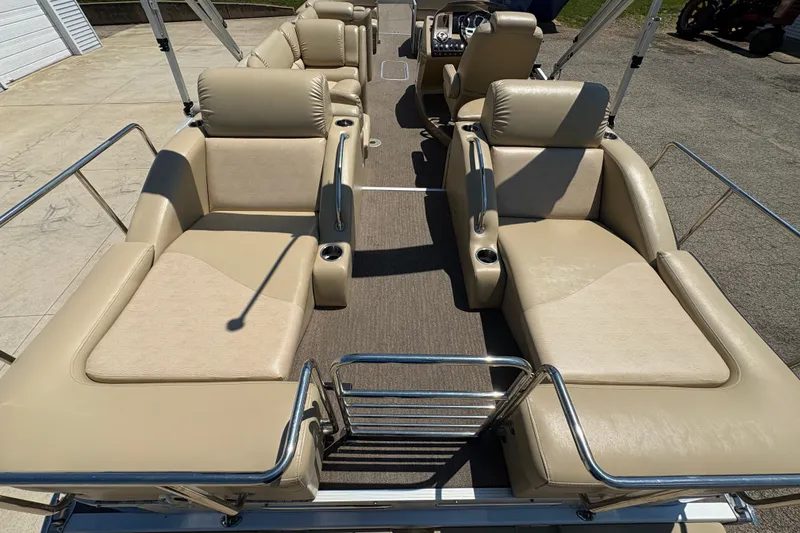 Slide: The Image of 2012 Bennington 2575 QCW I/O boat with beige leather seating and stainless steel railings. - 24