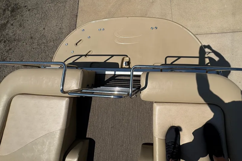 Slide: The Image of 2012 Bennington 2575 QCW I/O boat deck with beige seating and metal railings. - 29