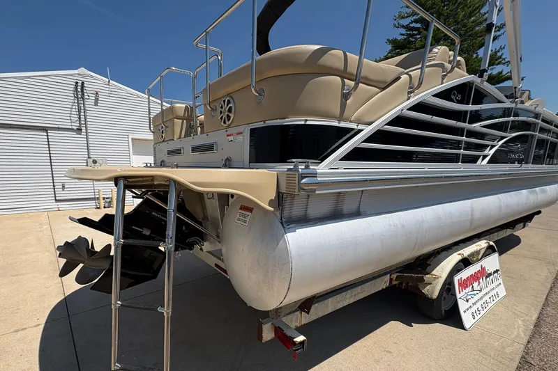 Slide: The Image of 2012 Bennington 2575 QCW I/O pontoon boat on trailer, rear view with ladder and propeller. - 33