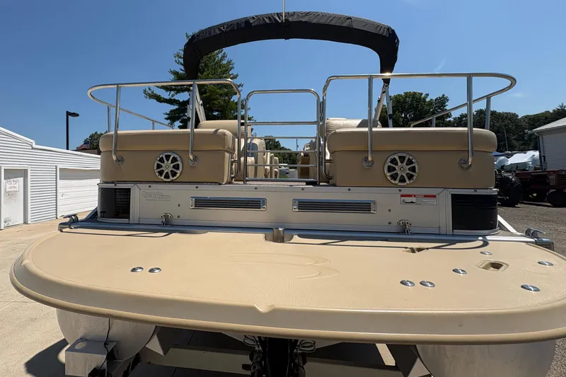 Slide: The Image of 2012 Bennington 2575 QCW I/O pontoon boat, rear view with seating and speakers. - 34