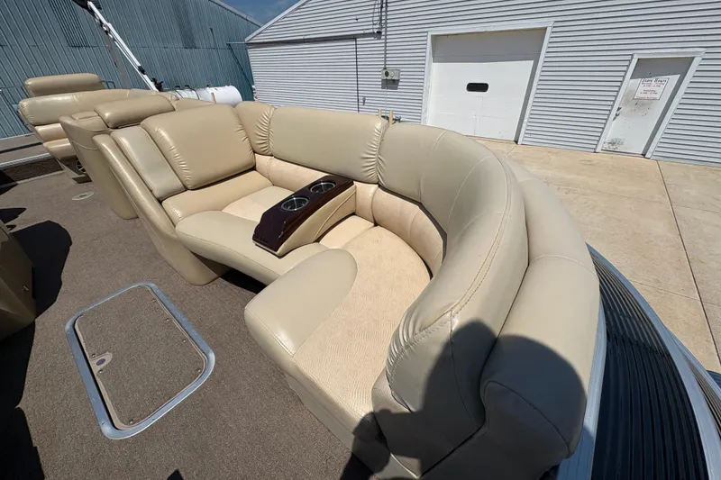 Slide: The Image of 2012 Bennington 2575 QCW I/O boat with beige leather seating and cup holders. - 9