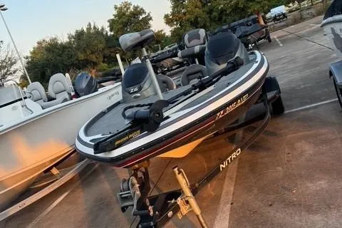 Slide: The Image of 2014 Nitra Boats Z6 in parking lot, surrounded by other boats. - 2