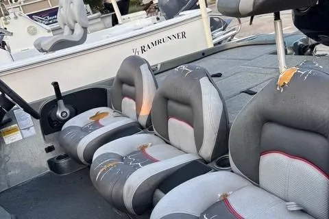 Slide: The Image of 2014 Nitra Boats Z6 interior with worn seats and visible damage. - 4